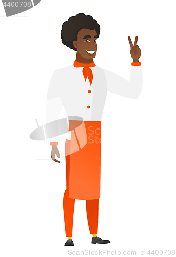 Image of African-american chef cook showing victory gesture