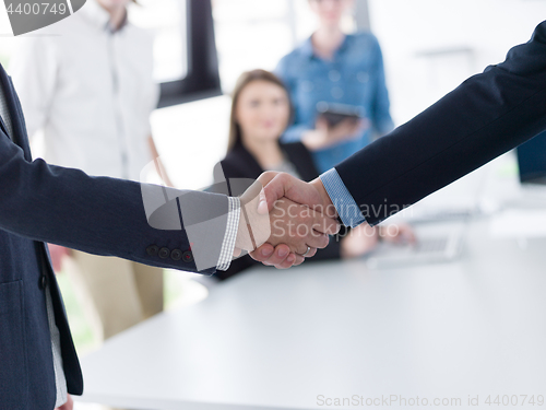 Image of cloasing the deal in modern office interior