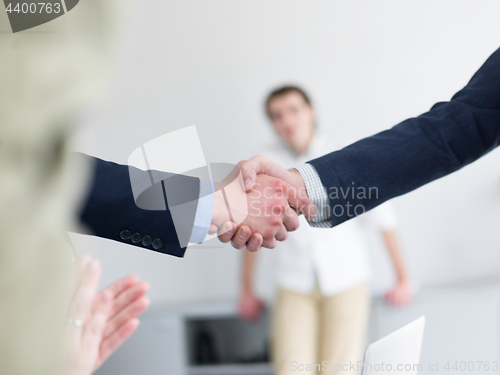 Image of cloasing the deal in modern office interior