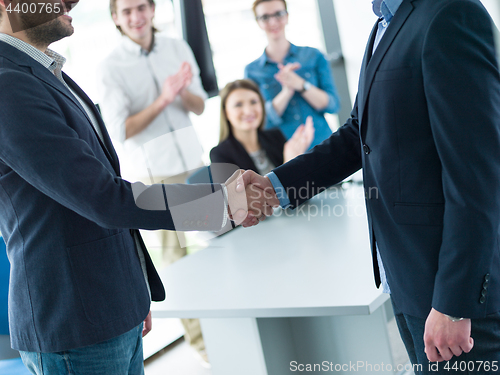 Image of cloasing the deal in modern office interior