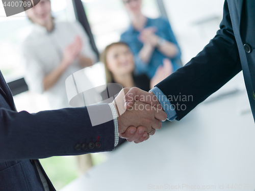 Image of cloasing the deal in modern office interior