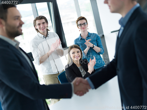 Image of cloasing the deal in modern office interior