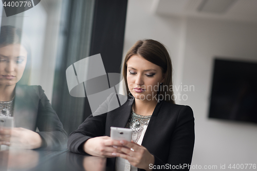 Image of Business Girl Standing In A Modern Building Near The Window With