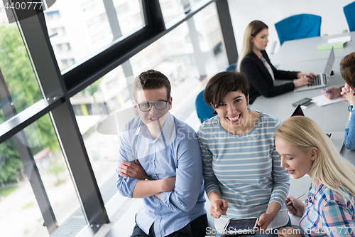 Image of group of Business People Working With Tablet in startup office