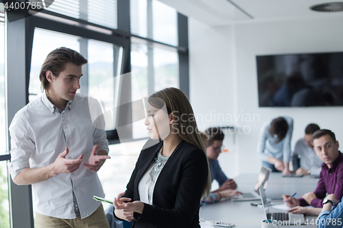 Image of Two Business People Working With Tablet in office