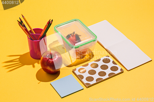 Image of Photo of office and student gear over yellow background