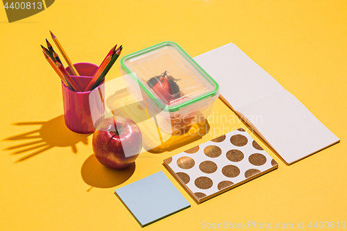 Image of Photo of office and student gear over yellow background