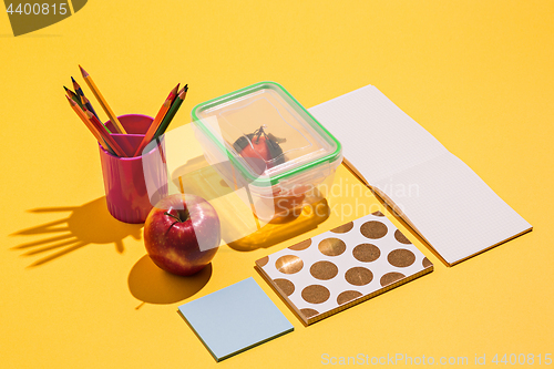 Image of Photo of office and student gear over yellow background