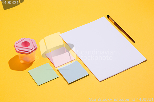 Image of The many empty paper clips, yellow background