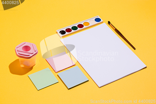 Image of The many empty paper clips, yellow background