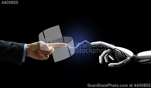 Image of robot and human hand connected by lightning