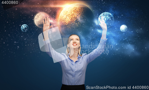 Image of happy businesswoman with virtual planets and space