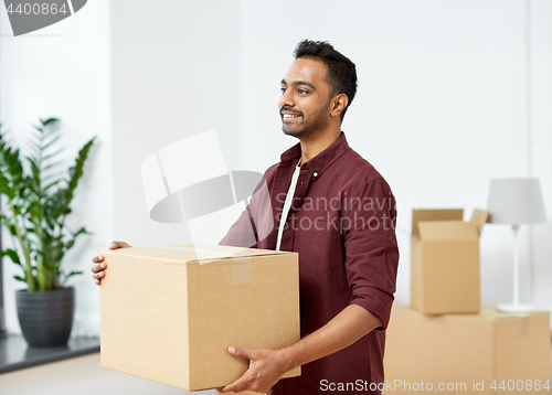 Image of happy man with box moving to new home