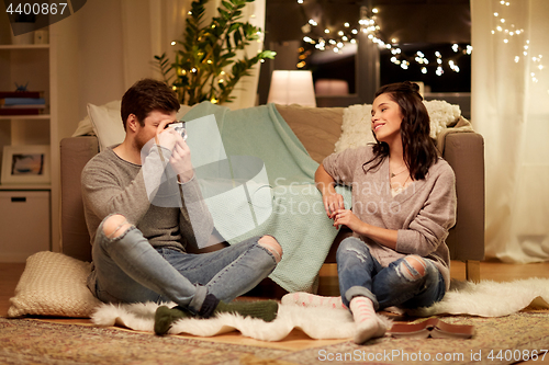 Image of happy couple with camera photographing at home