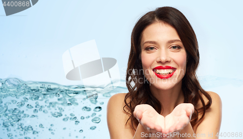 Image of beautiful smiling young woman with red lipstick