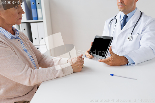 Image of senior woman and doctor with tablet pc at hospital