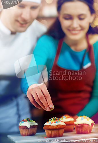 Image of happy woman and chef cook baking in kitchen