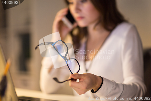 Image of woman with eyeglasses calling on smartphone