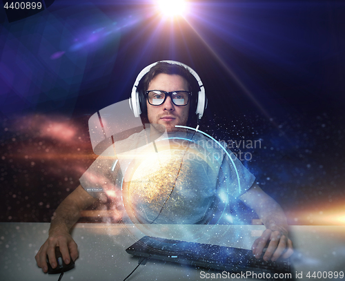 Image of man in headset playing computer video game