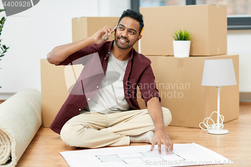 Image of man moving to new home and calling on smartphone