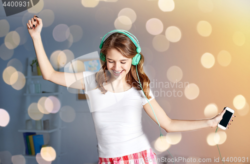 Image of happy woman in headphones ihaving fun at home