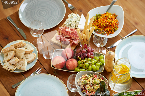 Image of various food on served wooden table