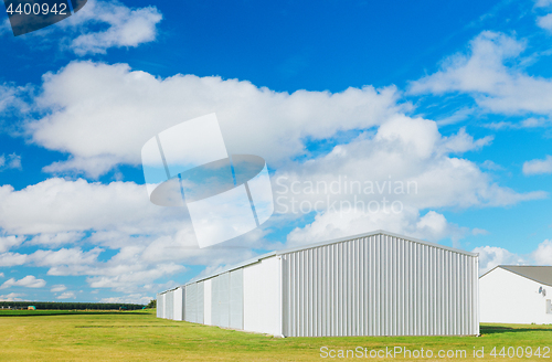 Image of Metallic warehouse with blue sky