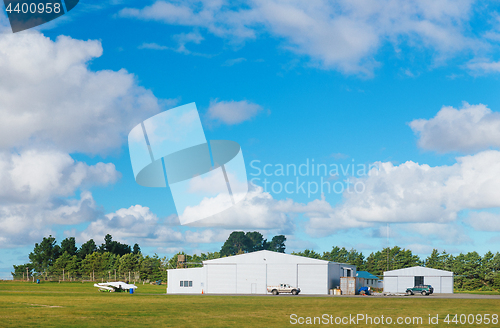 Image of Metallic warehouse with blue sky