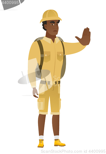 Image of African traveler showing stop hand gesture.