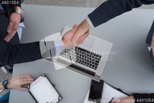 Image of cloasing the deal in modern office interior top view