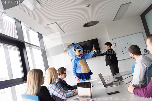 Image of boss dresed as bear having fun with business people in trendy of