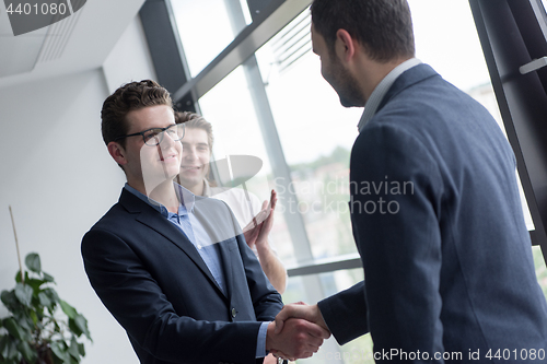 Image of cloasing the deal in modern office interior