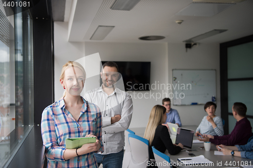 Image of Business People Working With Tablet in startup office