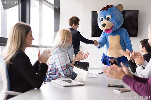 Image of boss dresed as bear having fun with business people in trendy of