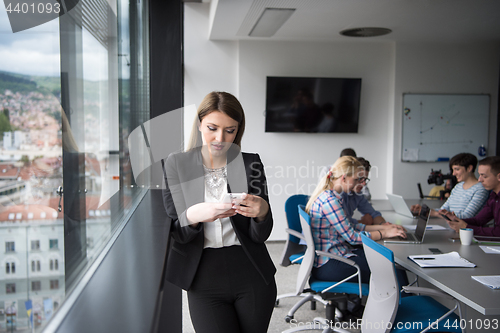 Image of Business Girl Standing In A Modern Building Near The Window With