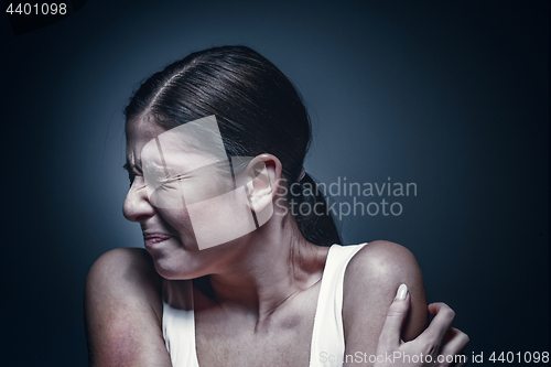 Image of Close up portrait of a crying woman with bruised skin and black eyes