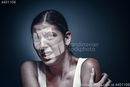 Image of Close up portrait of a crying woman with bruised skin and black eyes