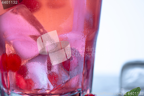 Image of closeup of a cape cod cocktail or vodka cranberry on a blue background