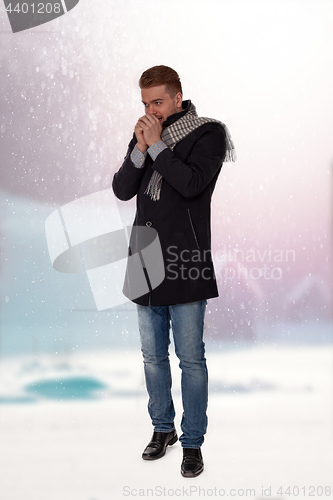 Image of Young man with cold hands