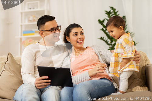 Image of mother, father and baby with tablet pc at home