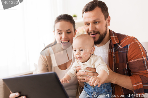 Image of mother, father and baby with tablet pc at home