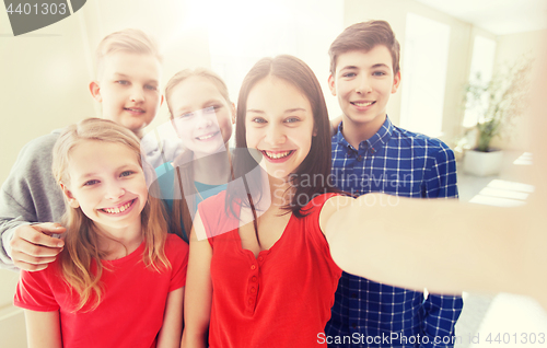 Image of group of students taking selfie with smartphone