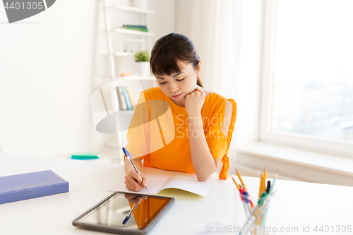 Image of asian student girl with tablet pc learning at home