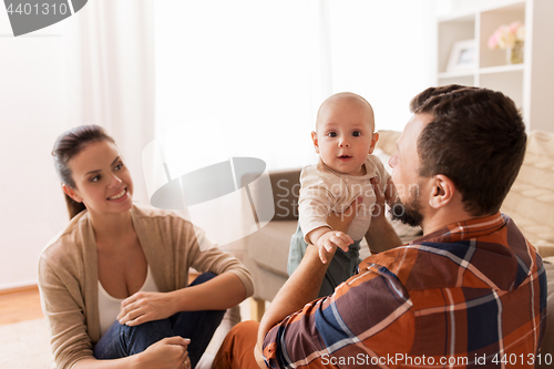 Image of happy family with baby at home