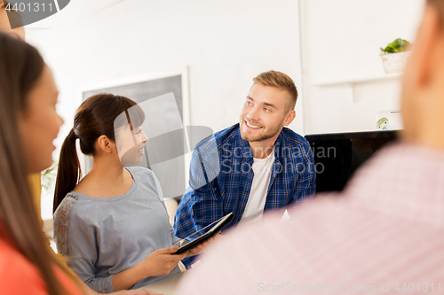 Image of creative team talking at office