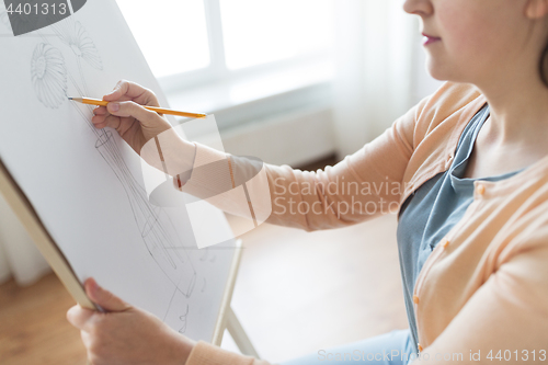 Image of artist with pencil drawing picture at art studio