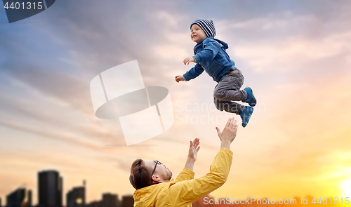 Image of father with son playing and having fun outdoors