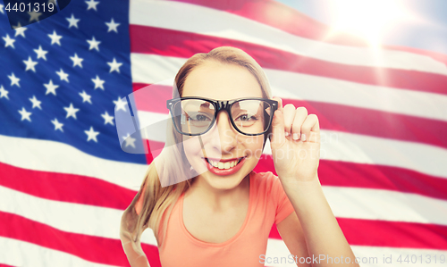 Image of happy young woman or teenage girl in eyeglasses