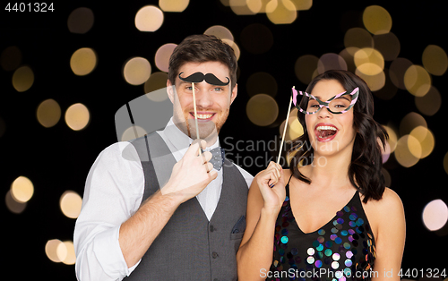 Image of happy couple with party props having fun