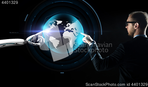 Image of businessman and robot with virtual earth hologram